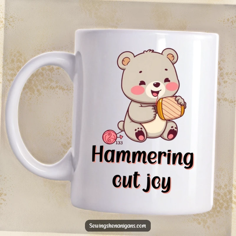 Funny jolly bear cub wearing a sewing thimble, enthusiastically hammering a spool, looking focused, on a mug, a cute funny gift.