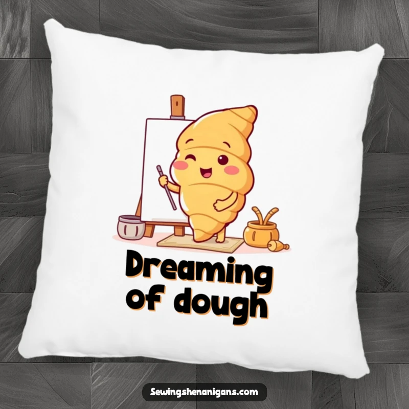 Funny pillow with a cheerful croissant character enthusiastically trying out a new, artistic pattern, adding comfort and humor.