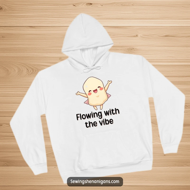 Funny hoodie: A delighted fabric scrap character cheerfully fluttering in a gentle breeze, offering warmth and humor.