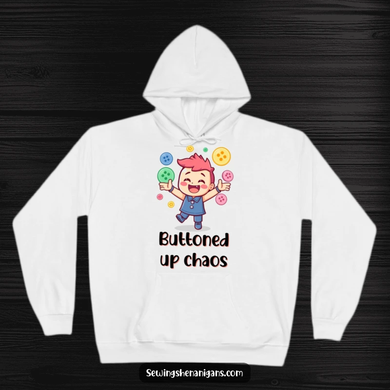 Funny hoodie showcasing a joyful character playfully juggling numerous colorful sewing buttons, offering warmth and humor.