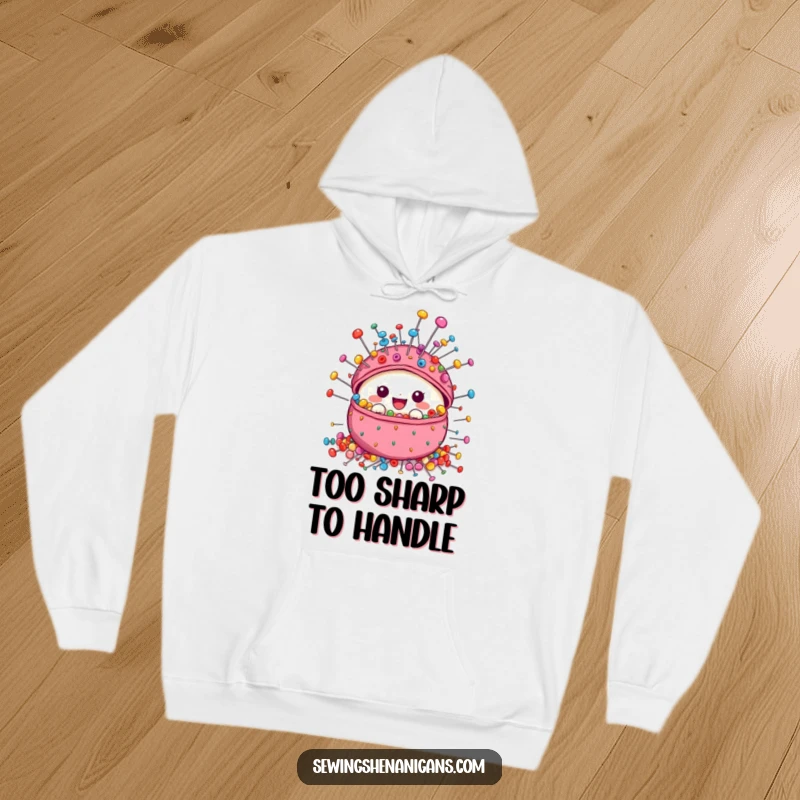 Funny Pincushion Hoodie with a cute, overflowing pincushion character and a vibrant array of colorful sewing pins, designed for comfort and style.