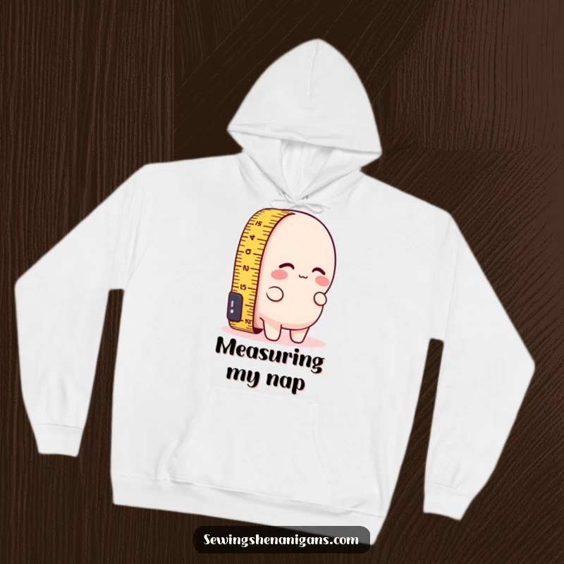 Funny hoodie featuring a measuring tape character comically trying to measure its own short length, offering a warm and humorous feel.