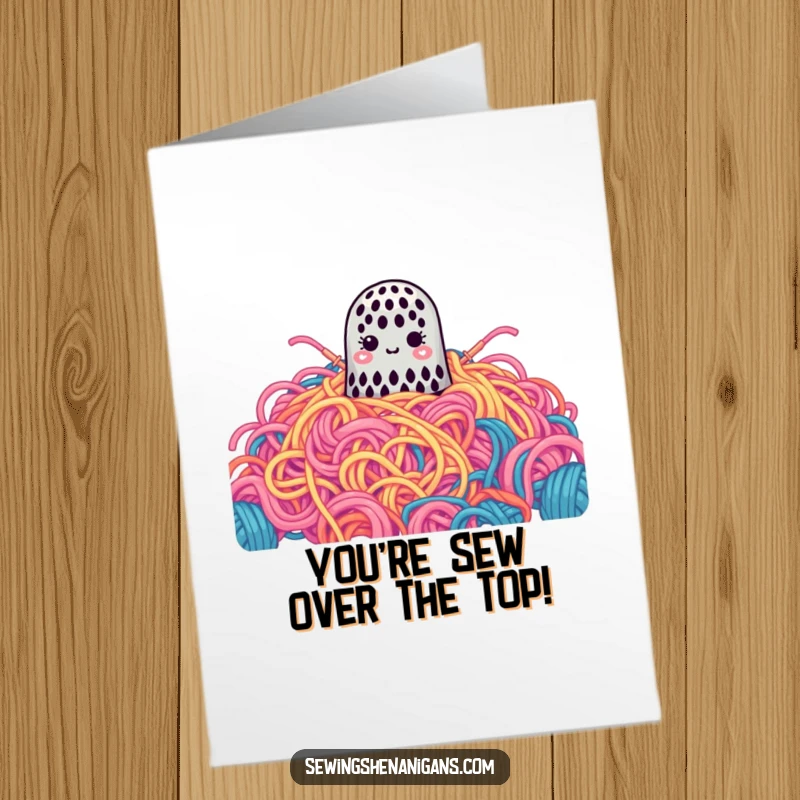 Funny Free Printable Congrats Card: A small thimble is comically lost within an enormous, vibrant heap of yarn, celebrating big.