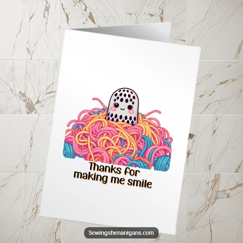 Funny Free Printable Thank You Card: A small thimble disappears into a gigantic, colorful pile of yarn, a sweet way to say thanks.