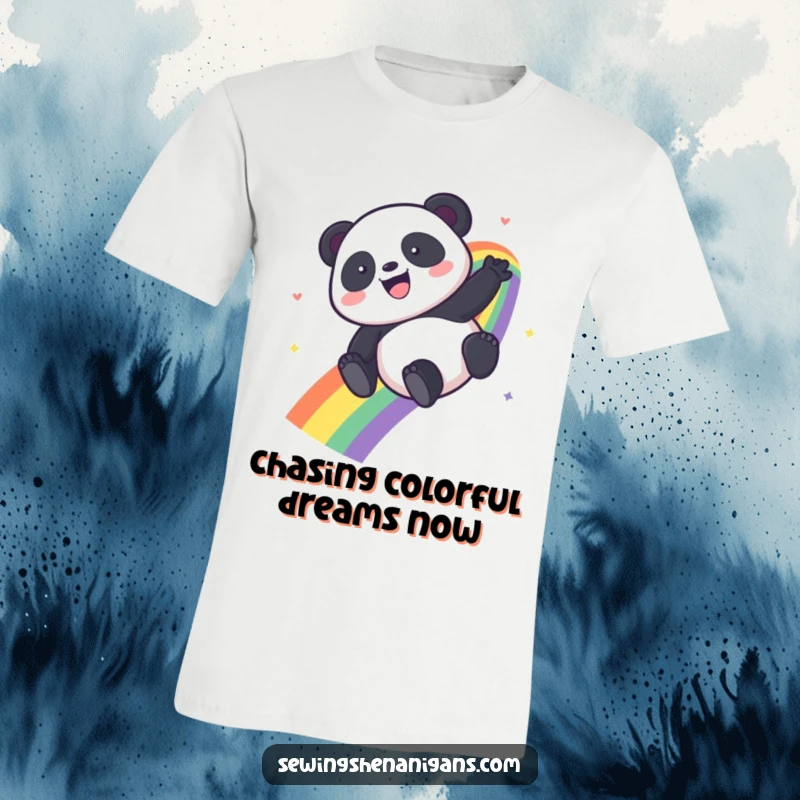 Funny Kawaii Panda t-shirt depicting a happy panda sliding down a bright rainbow, full of glee.