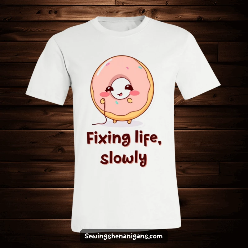 Funny Donut Stitching T-Shirt: A laughing donut character attempts to sew a hole with tiny thread, ideal for a funny gift.