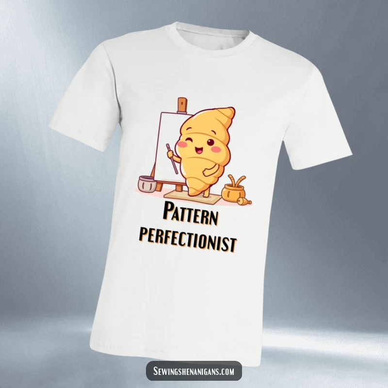 Funny t-shirt print of a happy croissant character enthusiastically exploring a vibrant new pattern, perfect for casual wear.