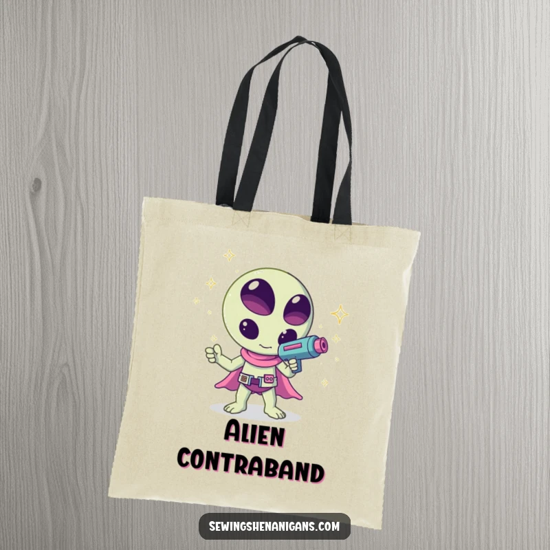 Funny kawaii alien waving a ray gun shooting sparkles, a humorous and creative design on this tote bag, great for shopping.